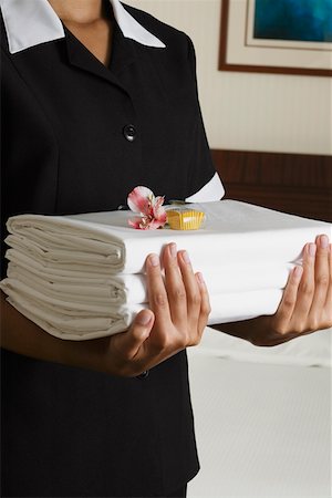 room service waiters uniforms - Candy, Close-Up, Color Image, Flower, Focus On Foreground, Front View, Holding, Indoors, Maid, Midsection, One Person, One Stock Photo - Premium Royalty-Free, Code: 625-01261485