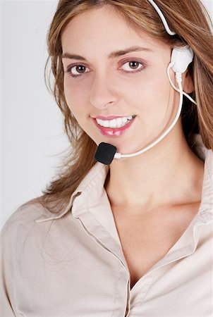 simsearch:625-01093712,k - Portrait of a female customer service representative talking on a headset and smiling Stock Photo - Premium Royalty-Free, Code: 625-01261604