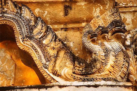 picture carved on stone wall close up - Close-up of a multi-headed dragon carved on a stone wall, Wat Si Sawai, Sukhothai, Thailand Stock Photo - Premium Royalty-Free, Code: 625-01261884