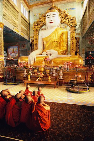 Rear view of monks praying in front of a statue of Buddha, Sagaing, Myanmar Stock Photo - Premium Royalty-Free, Code: 625-01262396