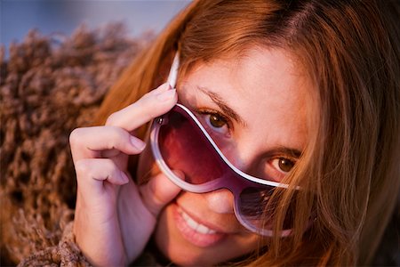 peeping fashion - Portrait of a mid adult woman peeking over her sunglasses Stock Photo - Premium Royalty-Free, Code: 625-01262438