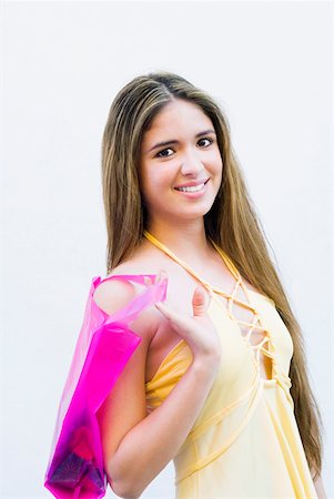 student latino business casual - Portrait of a teenage girl holding a shopping bag and smiling Stock Photo - Premium Royalty-Free, Code: 625-01262871