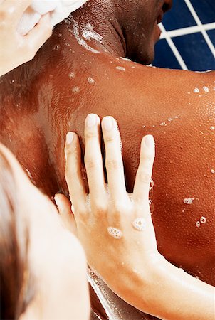 Close-up of a woman scrubbing a man's back Stock Photo - Premium Royalty-Free, Code: 625-01263040