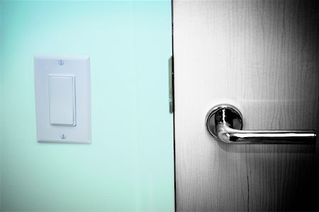 Close-up of a light switch near a door handle Stock Photo - Premium Royalty-Free, Code: 625-01263174