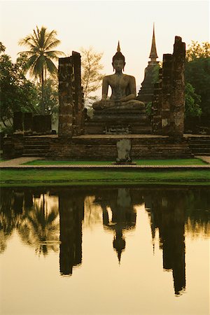 Reflection of a statue of Buddha in water, Wat mahathat, Sukhothai Historical Park, Sukhothai, Thailand Stock Photo - Premium Royalty-Free, Code: 625-01263206