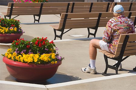 Rear view of a man sitting on a bench Stock Photo - Premium Royalty-Free, Code: 625-01263370