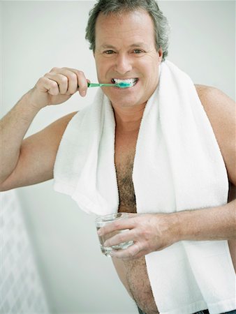 Portrait of a mature man brushing his teeth Stock Photo - Premium Royalty-Free, Code: 625-01263802