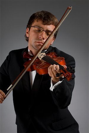 Close-up of a male musician playing a violin Stock Photo - Premium Royalty-Free, Code: 625-01744030