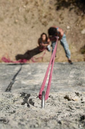 simsearch:625-01040859,k - High angle view of a male rock climber scaling a rock with a female rock climber looking at him Stock Photo - Premium Royalty-Free, Code: 625-01744244