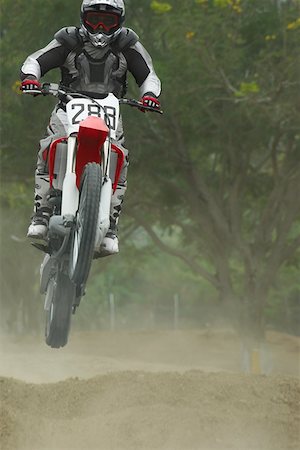 simsearch:625-01744331,k - Motocross rider performing a jump on a motorcycle Foto de stock - Sin royalties Premium, Código: 625-01744263