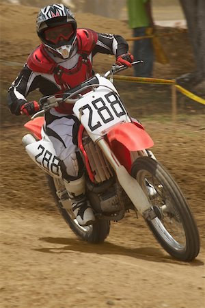 simsearch:625-01744331,k - Motocross rider riding a motorcycle and leaning into a turn Foto de stock - Sin royalties Premium, Código: 625-01744272