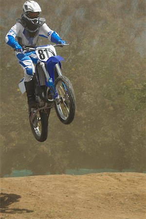 simsearch:625-01744331,k - Low angle view of a motocross rider performing a jump on a motorcycle Foto de stock - Sin royalties Premium, Código: 625-01744289