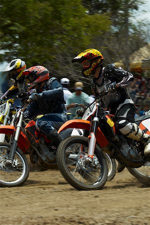 simsearch:625-01744655,k - Side profile of three motocross riders riding motorcycles Stock Photo - Premium Royalty-Free, Code: 625-01744319