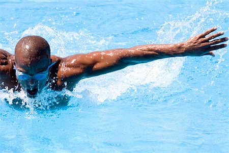simsearch:625-01038267,k - Mid adult man swimming the butterfly stroke in a swimming pool Stock Photo - Premium Royalty-Free, Code: 625-01744339