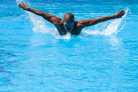 simsearch:625-01038267,k - Mid adult man swimming the butterfly stroke in a swimming pool Stock Photo - Premium Royalty-Free, Code: 625-01744364