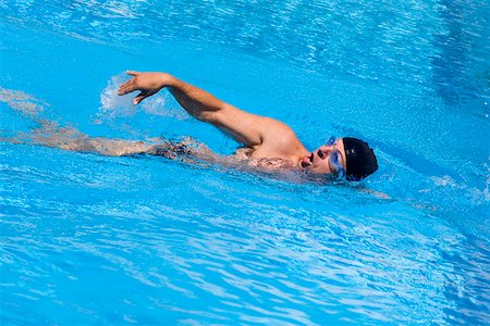 simsearch:625-01038267,k - Young man swimming in a swimming pool Stock Photo - Premium Royalty-Free, Code: 625-01744365