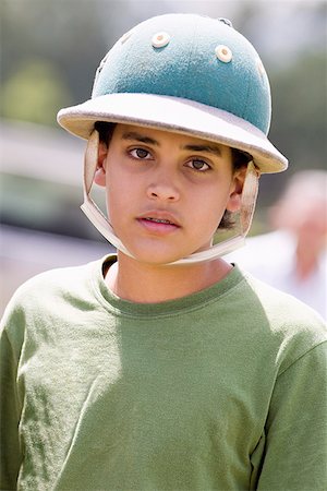 simsearch:625-01038259,k - Portrait of a teenage boy wearing a polo helmet Stock Photo - Premium Royalty-Free, Code: 625-01744498