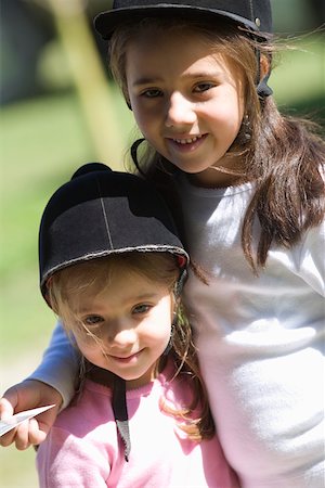 simsearch:625-01752943,k - Close-up of two girls wearing riding hats and smiling Stock Photo - Premium Royalty-Free, Code: 625-01744515