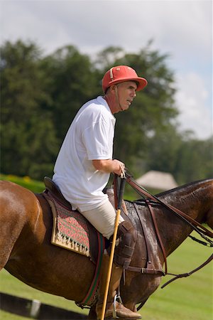 Side profile of a senior man playing polo Stock Photo - Premium Royalty-Free, Code: 625-01744546