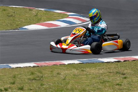 sport car speed - Person go-carting on a motor racing track Stock Photo - Premium Royalty-Free, Code: 625-01744675