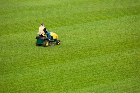 Side profile of a man mowing grass with a lawn mower in a field Foto de stock - Sin royalties Premium, Código: 625-01744737