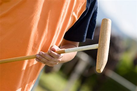 polo sport - Mid section view of a man holding a polo mallet Stock Photo - Premium Royalty-Free, Code: 625-01744731