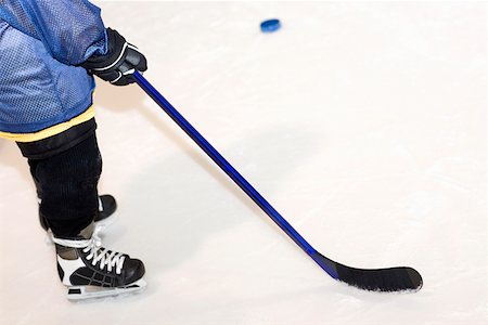 Low section view of a man playing ice hockey Stock Photo - Premium Royalty-Free, Code: 625-01744786