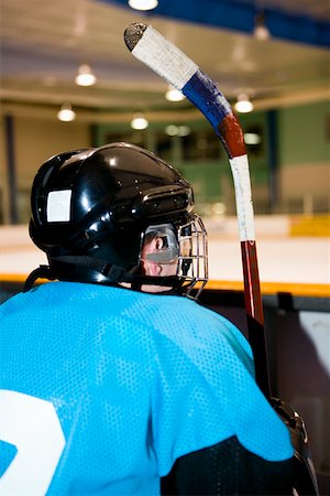 simsearch:625-01038051,k - Rear view of an ice hockey player sitting next to the railing of an ice rink Stock Photo - Premium Royalty-Free, Code: 625-01744795