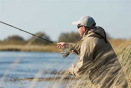Side profile of a mature man fishing Stock Photo - Premium Royalty-Free, Code: 625-01744855