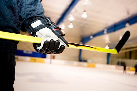 simsearch:625-01038051,k - Mid section view of an ice hockey player holding an ice hockey stick Stock Photo - Premium Royalty-Free, Code: 625-01744877