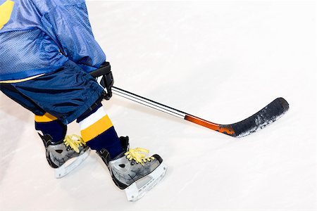 Rear view of a man playing ice hockey Stock Photo - Premium Royalty-Free, Code: 625-01744892