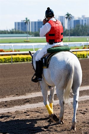 Rear view of a jockey riding a horse Stock Photo - Premium Royalty-Free, Code: 625-01744957