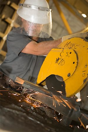 simsearch:625-01097225,k - Male construction worker working on an electric saw at a construction site Stock Photo - Premium Royalty-Free, Code: 625-01745765