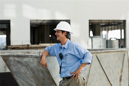 Side profile of an engineer leaning against an industrial equipment Stock Photo - Premium Royalty-Free, Code: 625-01745778