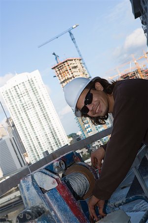 simsearch:625-01746692,k - Side profile of a male construction worker working at a construction site Foto de stock - Sin royalties Premium, Código: 625-01745772