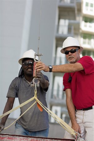 Two male construction workers working at a construction site Stock Photo - Premium Royalty-Free, Code: 625-01745787