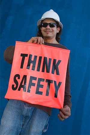 simsearch:625-01097225,k - Young man holding a banner of think safety Stock Photo - Premium Royalty-Free, Code: 625-01745794