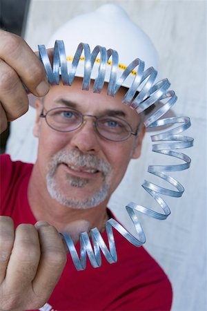 simsearch:625-01745814,k - Portrait of a male construction worker folding a metal spring and smiling Stock Photo - Premium Royalty-Free, Code: 625-01745797