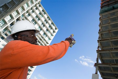 simsearch:625-01745814,k - Low angle view of a male construction worker pointing towards the building Stock Photo - Premium Royalty-Free, Code: 625-01745803