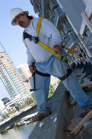 simsearch:625-01097225,k - Mature man standing at the edge of a building and holding a hammer Stock Photo - Premium Royalty-Free, Code: 625-01745814