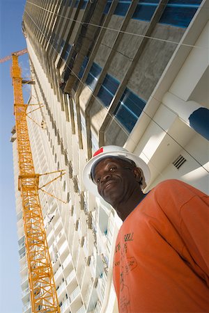 simsearch:625-01745814,k - Low angle view of a male construction worker standing in front of a building Stock Photo - Premium Royalty-Free, Code: 625-01745813
