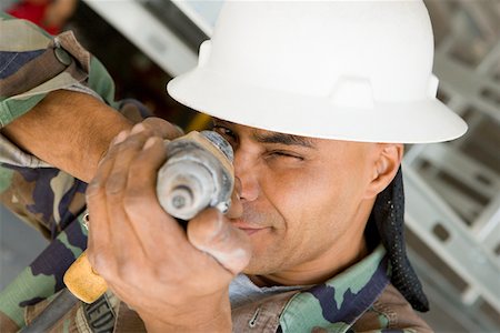 simsearch:625-01097225,k - Close-up of a male construction worker aiming with a hand drill Stock Photo - Premium Royalty-Free, Code: 625-01745829