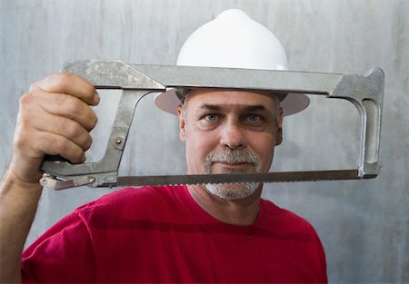 simsearch:625-01745814,k - Portrait of a mature man holding a coping saw Stock Photo - Premium Royalty-Free, Code: 625-01745822