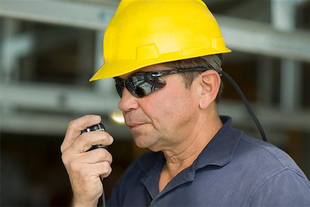 simsearch:625-01745814,k - Close-up of a male construction worker talking on a CB radio Stock Photo - Premium Royalty-Free, Code: 625-01745823