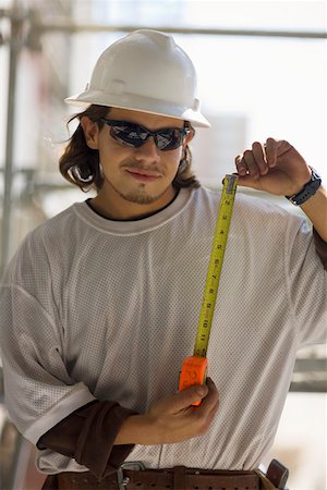 simsearch:625-01097225,k - Young man holding a tape measure Stock Photo - Premium Royalty-Free, Code: 625-01745838