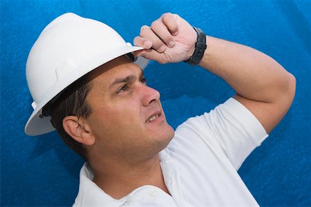 simsearch:625-01745814,k - Close-up of a male construction worker adjusting his hardhat Stock Photo - Premium Royalty-Free, Code: 625-01745839