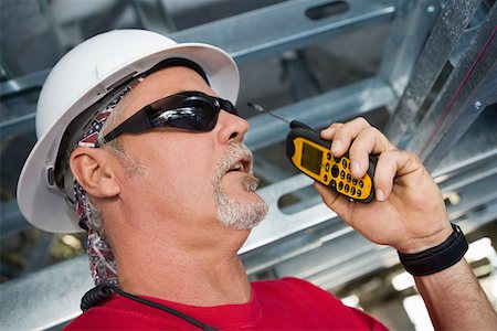 simsearch:625-01097231,k - Close-up of a male construction worker talking on a walkie-talkie Stock Photo - Premium Royalty-Free, Code: 625-01745832