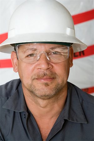 simsearch:625-01745814,k - Portrait of a mature man with a pair of protective eyewear and a hardhat Stock Photo - Premium Royalty-Free, Code: 625-01745842