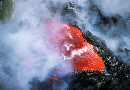 Steam rises from lava flowing into the sea, Hawaii Stock Photo - Premium Royalty-Free, Code: 625-01746081