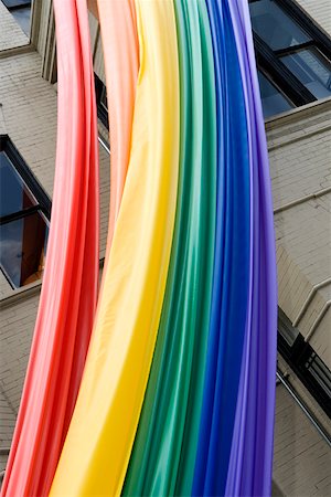 simsearch:625-01746293,k - Low angle view of a rainbow flag hanging on a building Foto de stock - Royalty Free Premium, Número: 625-01746294